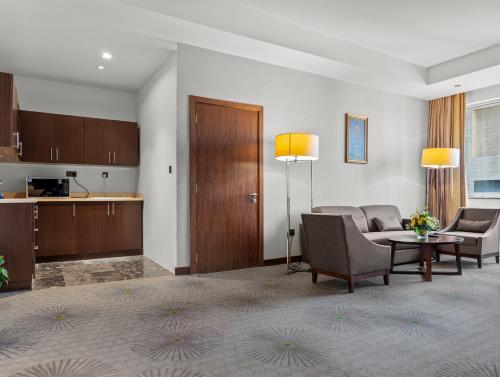 a living room with a couch and a table at Holiday Suites Al Azizia in Makkah