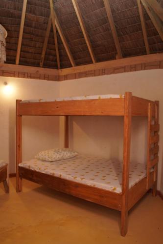 a bunk bed in a room with a ceiling at AFLII Beach Club ( Zanzibar Beach ) in Mtwara