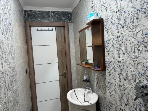 a bathroom with a sink and a toilet and a mirror at Relaxation, fresh air, and a direct view of the Nile in Naj‘ al ‘Amrāb