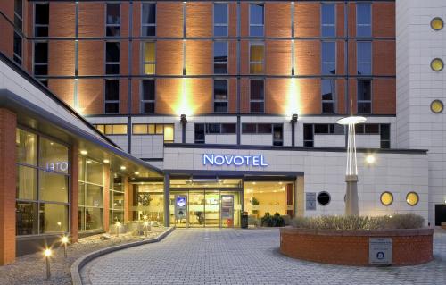 a large building with a clock on the side of it at Novotel Leeds Centre in Leeds