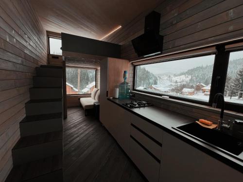 a kitchen with a sink and a window in a house at Небокрай in Palyanytsya