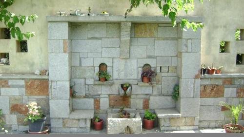 a stone wall with potted plants on it at Irene Villa in Ierápetra
