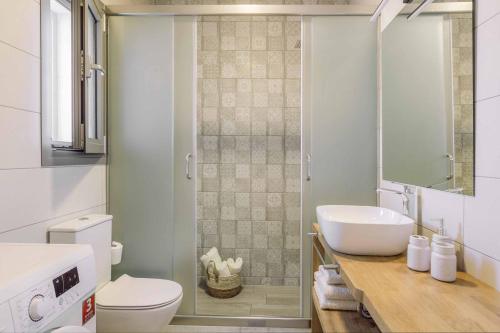 a white bathroom with a sink and a toilet at Villa Vitalia in Lakithra