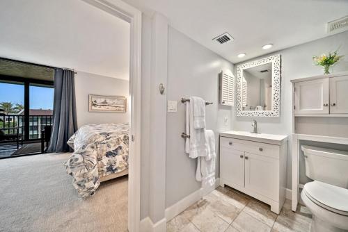 a bathroom with a bed and a toilet and a sink at Loggerhead Cay #324 in Sanibel