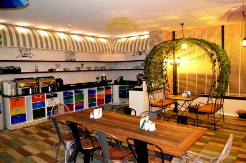 a restaurant with a table and chairs and a kitchen at Tempo Fair Suites in Istanbul