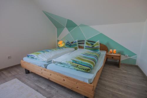 a bedroom with a bed with a geometric headboard at Ferienwohnung Kollmer in Ebern