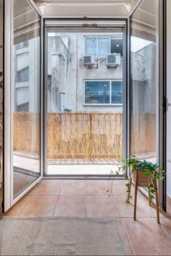 an empty room with a large window and a bench at STM Monastiraki Acropolis Apt in Athens