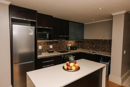 a kitchen with a bowl of fruit on a counter at Mandela Rhodes Place in Cape Town