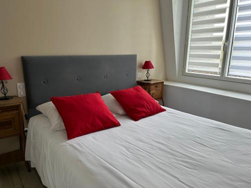 ペロンヌにあるChambres d'Hotes Noir Lionのベッドルーム1室(白いベッド1台、赤い枕2つ付)
