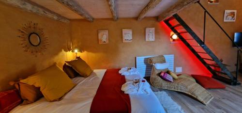 a bedroom with a bed and a staircase in it at Demeure de la Baronne in Vézénobres