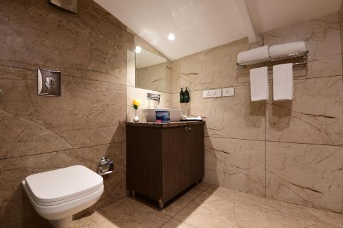 a bathroom with a toilet and a shower at Ramada by Wyndham Kasauli in Kasauli