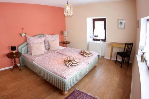 a bedroom with a bed and a table and a chair at Mosel Cottage in Piesport in Piesport