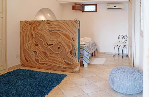 a room with a wooden wall with a blue rug at Terra e mare in Pantelleria