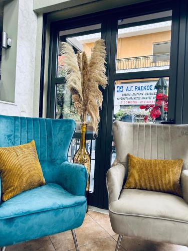 two chairs and a couch in front of a store at Mc Queen Rooms & Apartments in Athens