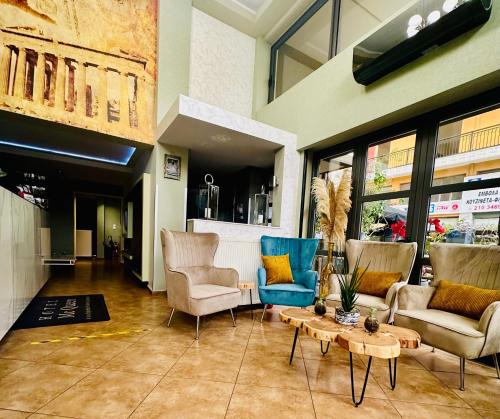 a living room with chairs and a coffee table at Mc Queen Rooms & Apartments in Athens
