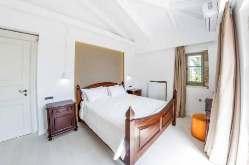 a bedroom with a large bed and a window at Villa Archontiko in Makris Gialos