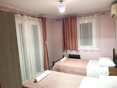 a hotel room with two beds and a window at Amazing seaview apartment in Avliotes village Corfu in Avliótai