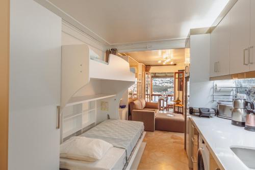 a small room with a bed and a kitchen at Marvelous Seaview Holiday Home Kalkan in Kalkan