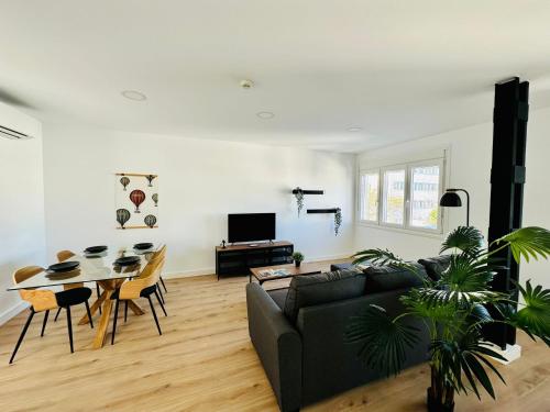 a living room with a couch and a table at La Muralla Playa y Ascensor Grupo AC Gestion in Cádiz