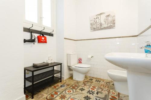 a bathroom with a white toilet and a sink at Tierra & Mar Ascensor Grupo AC Gestion in Cádiz