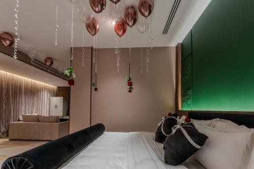 a bedroom with a large bed with a green wall at Lilac Park Hotel in Tabuk