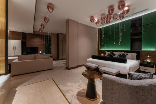a bedroom with a bed and a living room at Lilac Park Hotel in Tabuk