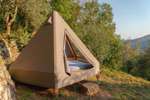 a tent sitting on the side of a hill at Tipì - Glamping Experience in Chiusanico
