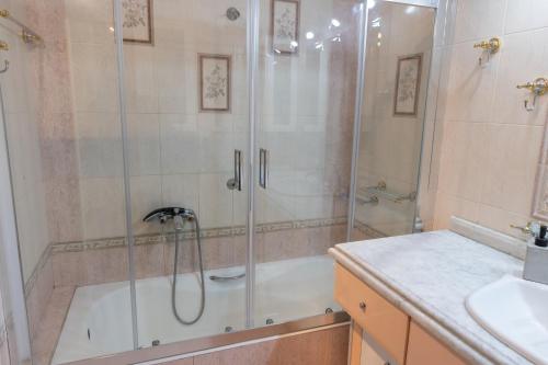 a bathroom with a shower and a sink at Spartan 5th floor apartment in Sparti