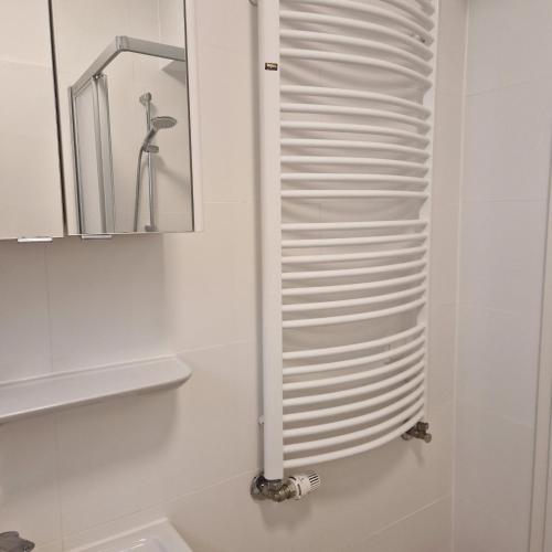 a white bathroom with a mirror and a sink at Ferienwohnung Rügen Breege in Breege
