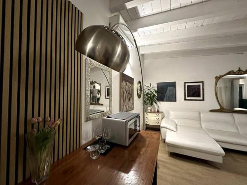 ein Wohnzimmer mit einem weißen Sofa und einem TV in der Unterkunft Lodi Suite in Mailand