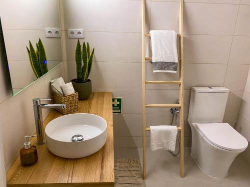 a bathroom with a toilet and a sink at Casa Longa Faro Entire House - Plunge Pool and Terrace in Faro