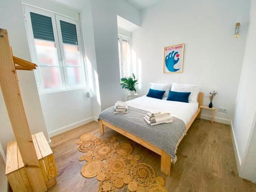 a small bedroom with a bed and a window at Casa Longa Faro Entire House - Plunge Pool and Terrace in Faro
