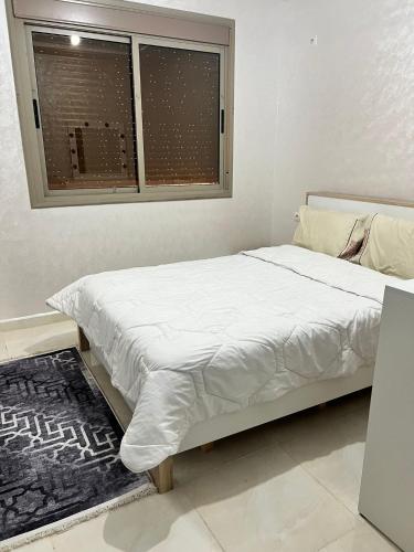 Postel nebo postele na pokoji v ubytování شقق إقامة الامل