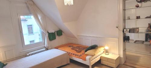 a small bedroom with a bed and a window at 2 Zimmer Zentral-ruhig mit Flair Gertrud Schlössli in St. Gallen