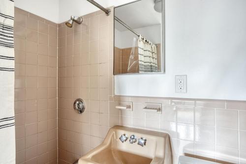 a bathroom with a sink and a shower with a mirror at Back Bay 1br w wd nr Newbury St BOS-725 in Boston