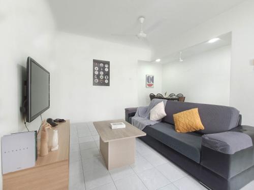 a living room with a couch and a tv at 31 Damansara Damai by Manhattan Group in Petaling Jaya