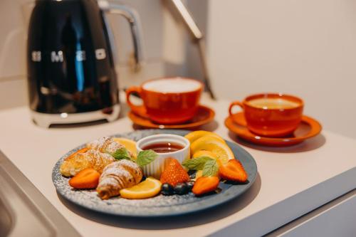 a plate of food with fruit on a counter at Five Seasons Szklarska Poręba in Szklarska Poręba