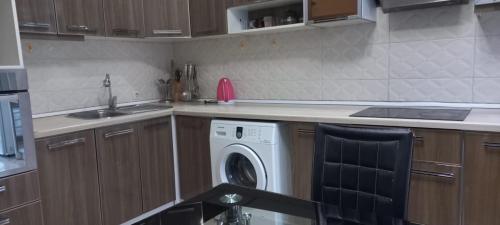 a kitchen with a washing machine and a sink at Акбар Хакимов in Dushanbe