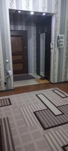 a bathroom with a door and a tile floor at Акбар Хакимов in Dushanbe