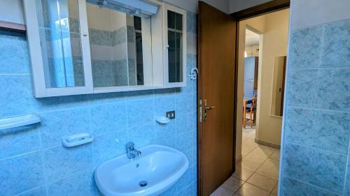 a bathroom with a sink and a mirror and a shower at Fontana Home in Domodossola
