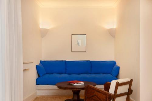 a blue couch in a living room with a table at Portella Palma in Palma de Mallorca