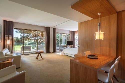 un salon avec une table et une chambre dans l'établissement Onyria Marinha Cascais, Vignette Collection by IHG, à Cascais
