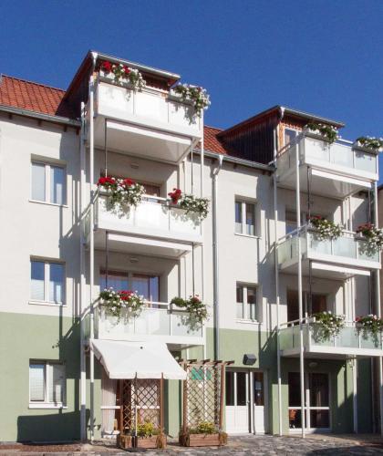 a large white building with flowers on the balconies at Ferienresidenz Schlossblick in Quedlinburg