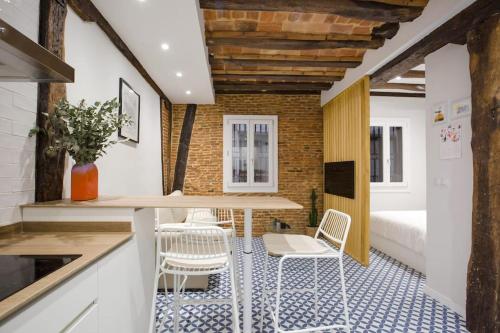 a kitchen with a table and chairs and a bedroom at Etxeburu (Apto Casco Viejo) in Bilbao