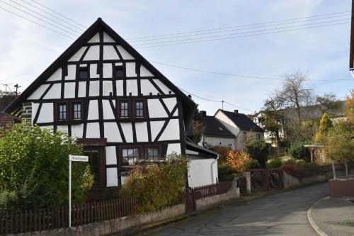 an old black and white building on a street at Das Pautzen Haus 