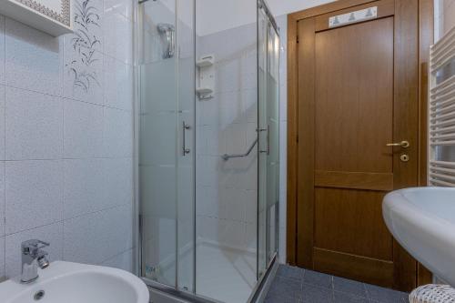 a bathroom with a shower and a toilet and a sink at San Gregorio Magno Apartment in Ferrara