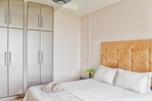 a bedroom with a bed with two towels on it at Breakers 419 by Top Destinations Rentals in Durban