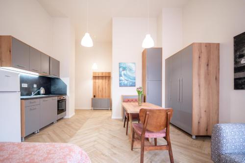 a kitchen and dining room with a table and chairs at WOW studios for rent - bul Montevideo 25A - B in Sofia