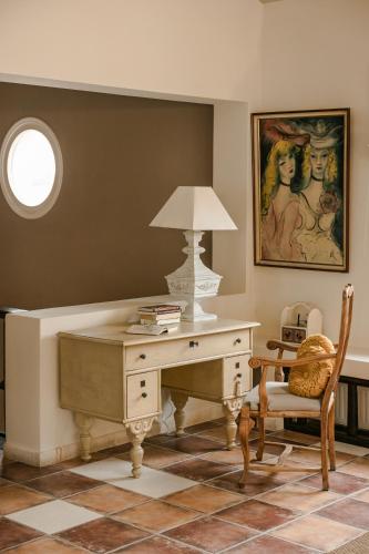 a desk with a lamp and a chair in a room at Scorpios Mansion Loft / Downtown Skala / Seaside in Skala Kefalonias