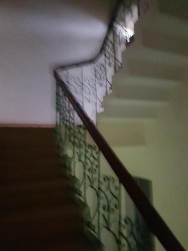 a staircase with a metal railing and a stair case at Mr. Hợp in Kim Côn